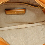 Beige herringbone fabric interior with TORY BURCH logo patch inside zippered bag