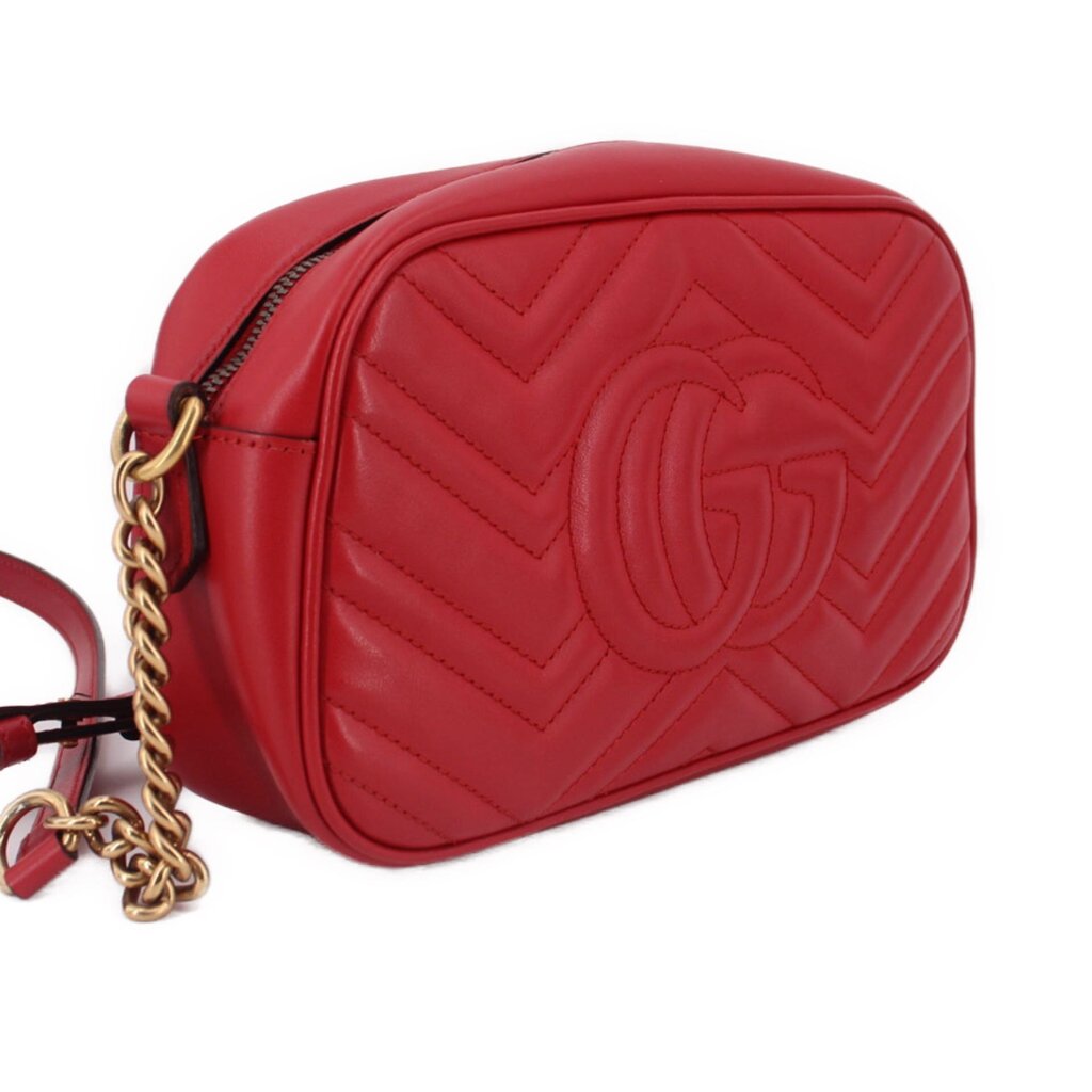 Red leather camera crossbody bag, side profile with gold-tone chain strap
