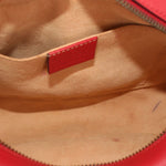 Close-up of red interior label and beige lining inside red camera crossbody bag