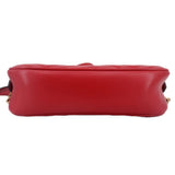 Red leather camera crossbody bag, back view with smooth base and stitched edge