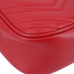 Close-up of red quilted leather camera crossbody bag interior seam detail