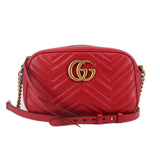 Red quilted leather camera crossbody bag with GG logo and chain strap