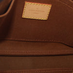 Close-up of interior label patch with stitching on monogram pouch lining