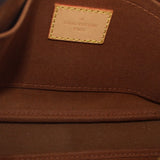 Close-up of interior label patch with stitching on monogram pouch lining