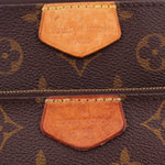 Close-up of tan leather tabs stamped 'Louis Vuitton Paris' on monogram Multi Pochette