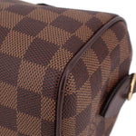 Damier Ebene crossbody bag side panel close-up with patterned canvas