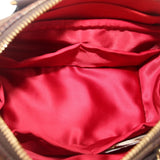 Crossbody bag open interior with red satin-like lining and zipper trim