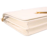 Cream Saffiano leather corner detail with gold-tone hardware and stitching