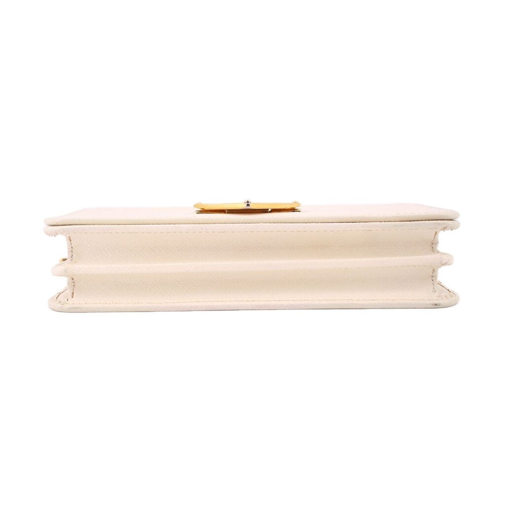 Cream Saffiano crossbody bag underside view with gold-tone clasp hardware