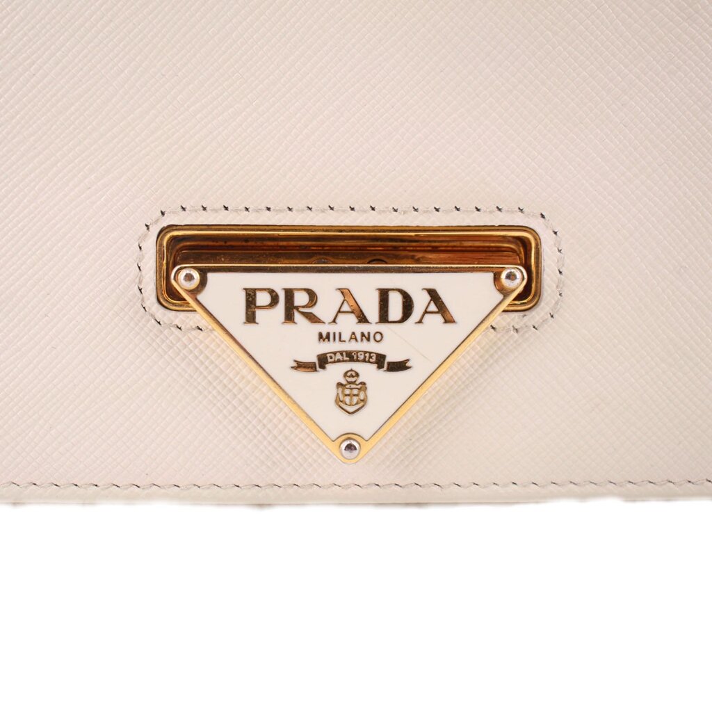 PRADA triangle logo plaque on cream Saffiano leather