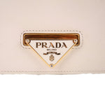 PRADA triangle logo plaque on cream Saffiano leather