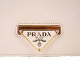 PRADA triangle logo plaque on cream Saffiano leather