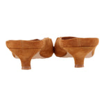 Camel suede mule pair shown from heel side, low stacked heel