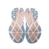 Shoe outsole view: light tread with blue rubber sections on black sneakers