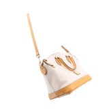Taupe Carissa satchel shown in side view with crossbody strap and tan-trimmed bottom edge.