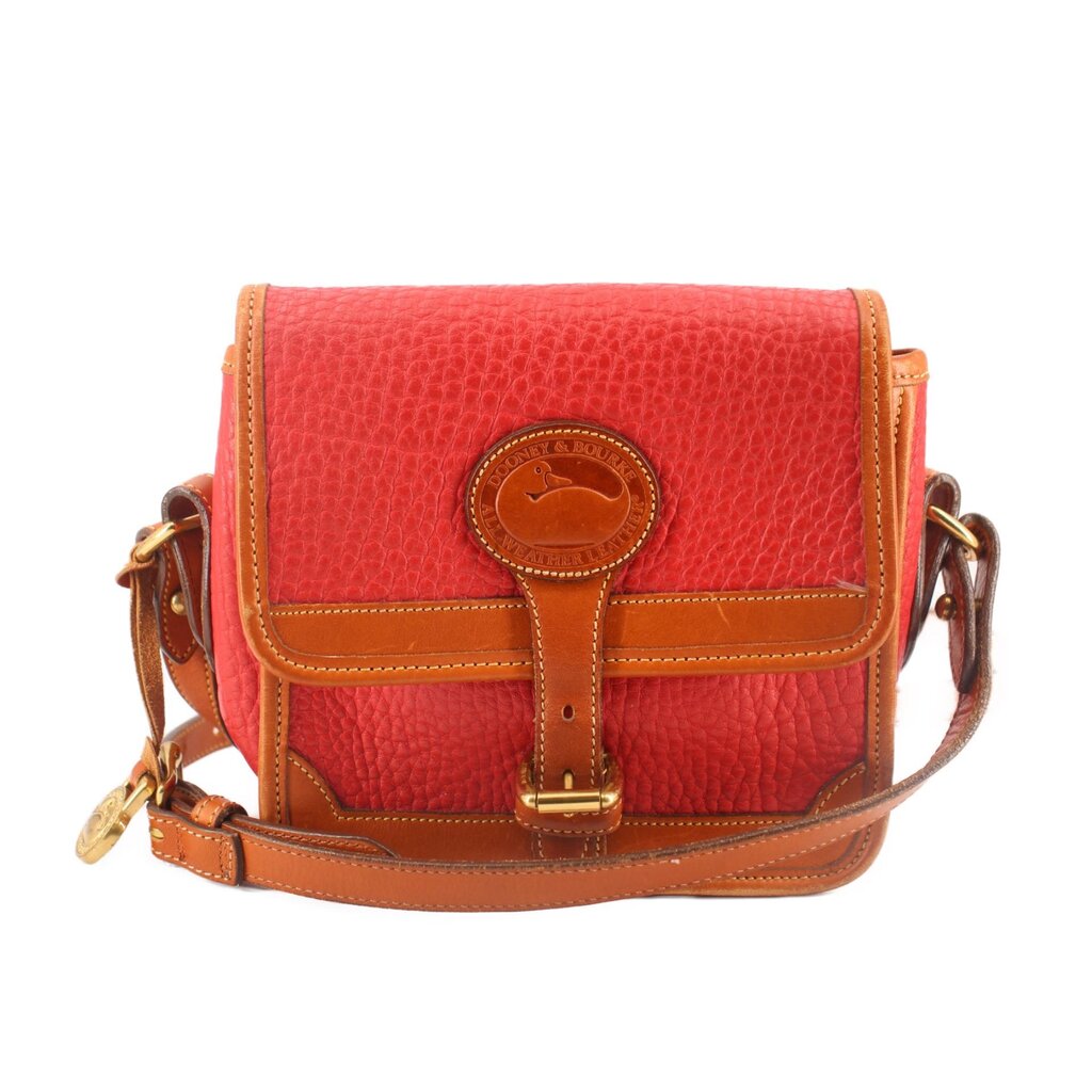 Red all-weather crossbody bag with tan flap, buckle ornament, and adjustable shoulder strap