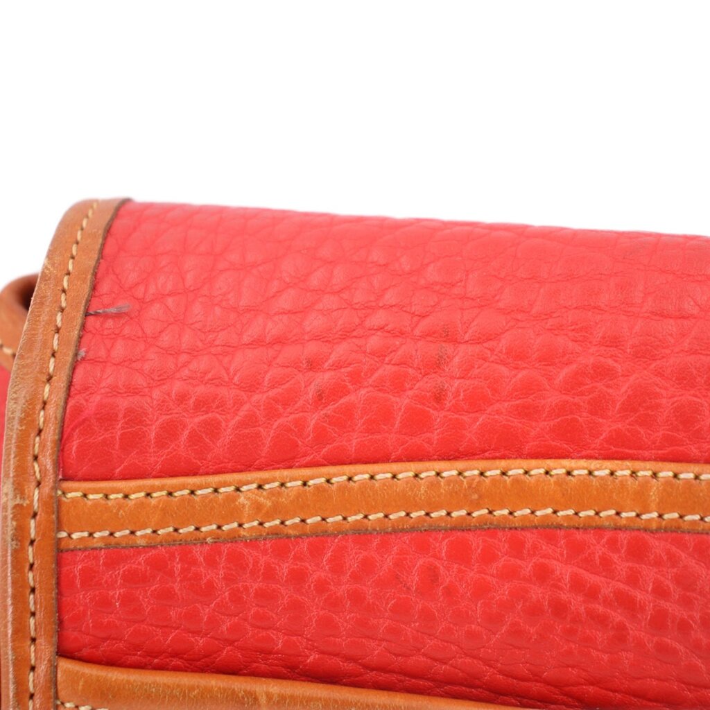 Red crossbody flap with tan stitched edge and textured leather grain detail