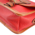 Red leather crossbody with tan stitching and panel trim along the front flap