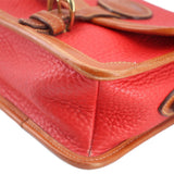 Red leather crossbody with tan stitching and panel trim along the front flap