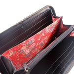 Wallet interior with red floral lining, black card slots, and gold-tone zipper.