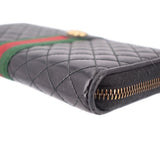 Black quilted leather wallet corner with gold-tone zipper and stitching detail.