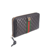 Black quilted wallet with gold-tone zipper and green/red Web stripe, side view.