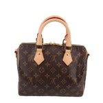Louis Vuitton monogram crossbody bag, front view with tan leather tabs and handles