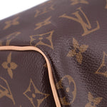 Louis Vuitton monogram bag corner close-up, dark brown canvas with tan edge piping