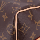 Louis Vuitton monogram bag edge close-up, dark brown canvas with tan leather trim