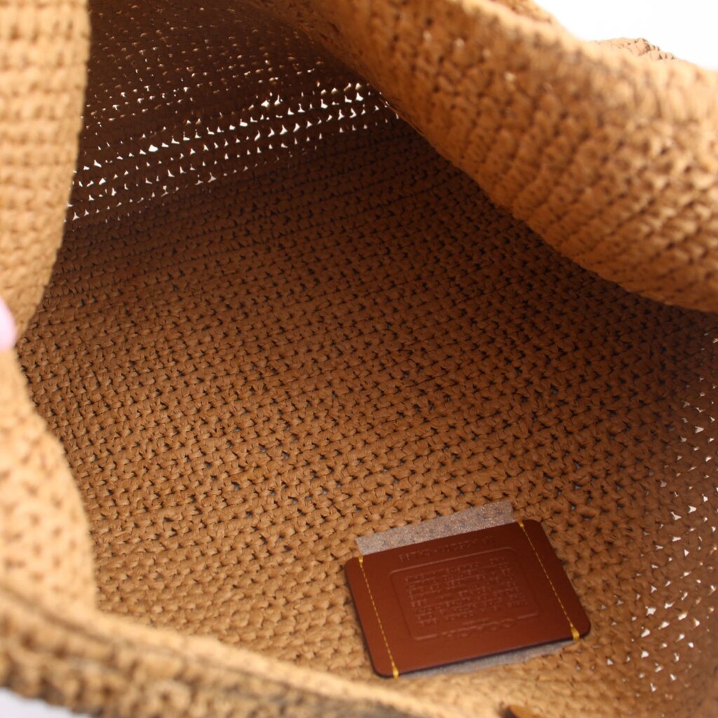 Raffia shoulder bag interior view with leather brand patch