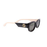 GUCCI black sunglasses with gold logo on temple and dark lenses