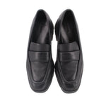 Pair of black leather slip-on loafers with rounded toe and simple stitched panels