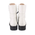 White lace-up boots with padded collars and black lug rubber soles