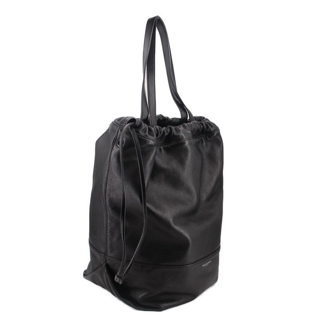 Black leather drawstring tote bag with long handles and gathered top opening