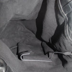Interior of black drawstring tote bag with visible pocket and metal D-ring.