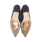 Navy flat shoe bottoms with visible wear and scuffs