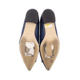 Navy flat shoe bottoms with visible wear and scuffs
