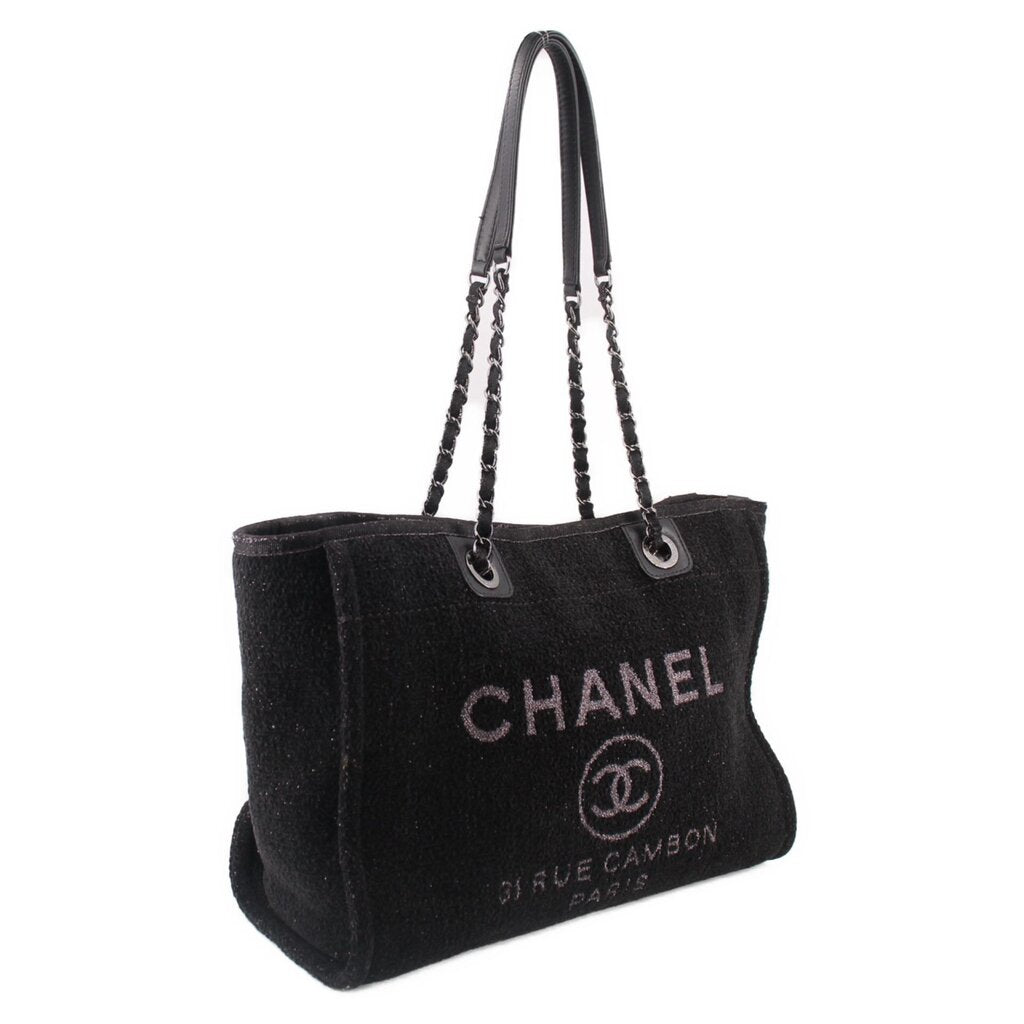 Black CHANEL tote bag with chain handles, rounded top, and front logo print