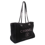 Black CHANEL tote bag with chain handles, rounded top, and front logo print