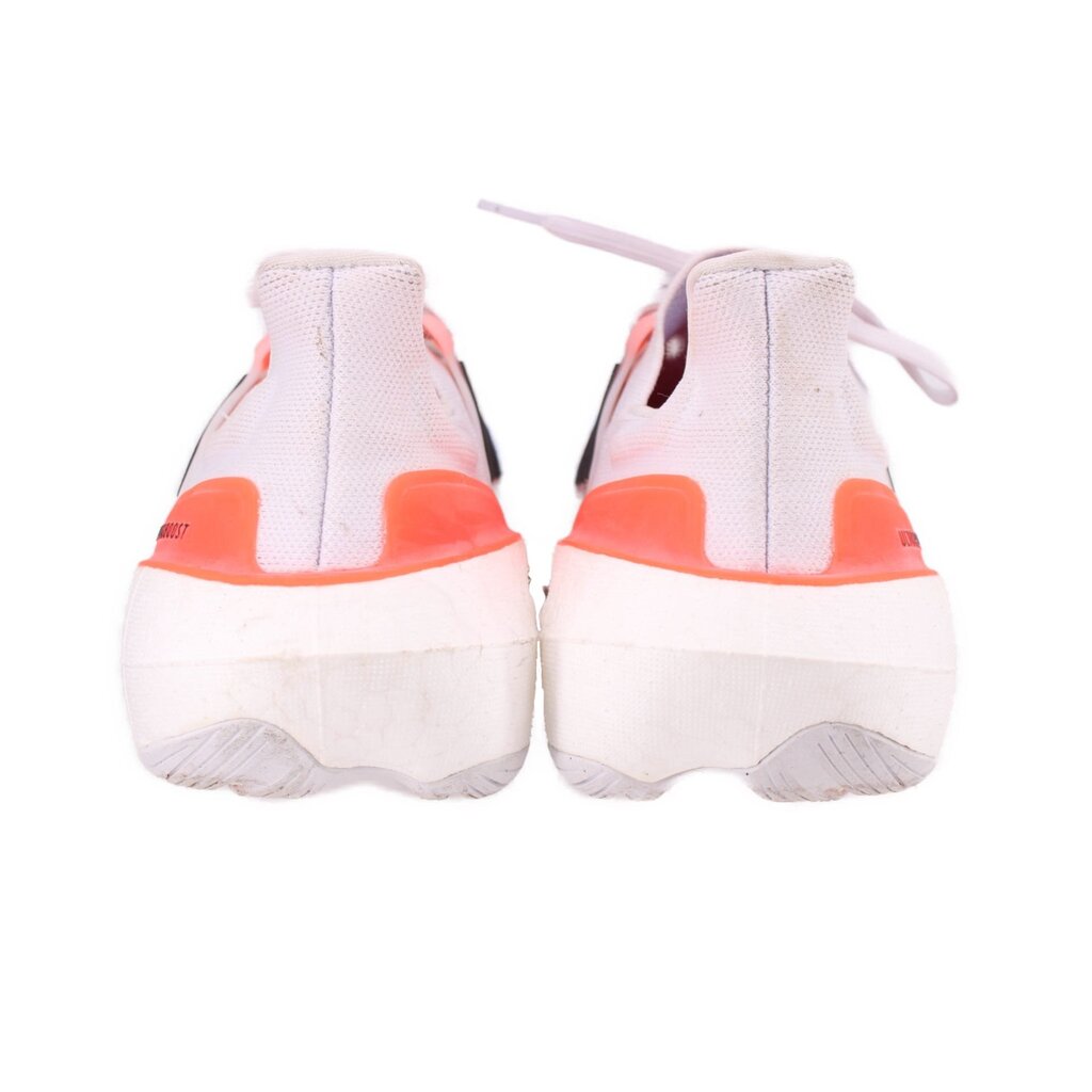 White mesh sneakers with orange heel tabs and rear cushioning, lace-up design
