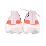 White mesh sneakers with orange heel tabs and rear cushioning, lace-up design