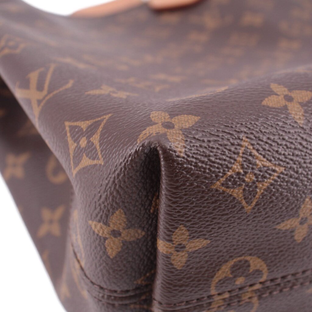Louis Vuitton monogram canvas bag corner detail with textured leather edge stitching