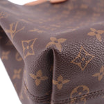 Louis Vuitton monogram canvas bag corner detail with textured leather edge stitching