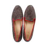 Pair of calf hair loafers with red-trimmed vamps and round toes; inner lining visible
