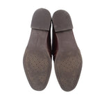 Brown loafer outsoles with textured tread pattern