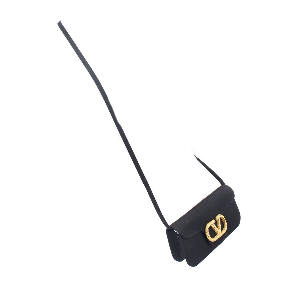 Black crossbody shoulder strap with small gold-tone logo charm near the end