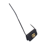 Black crossbody shoulder strap with small gold-tone logo charm near the end