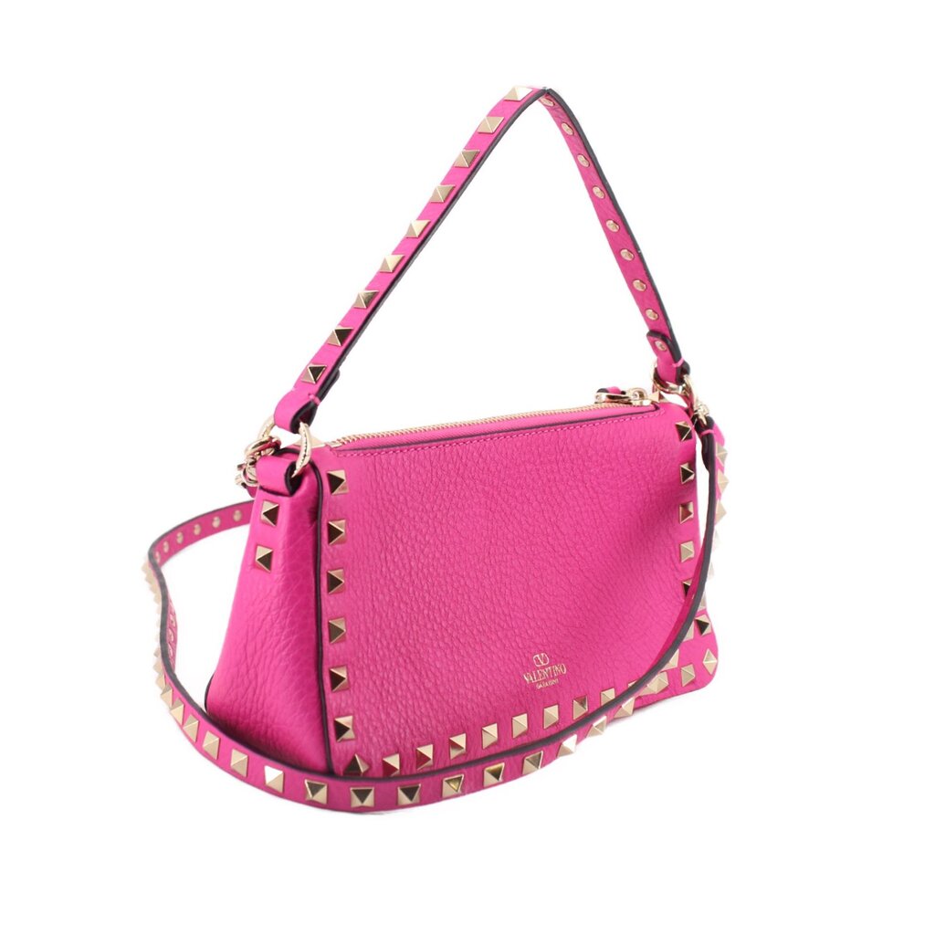 Pink crossbody bag with gold Rockstud border, top zip, and shoulder strap