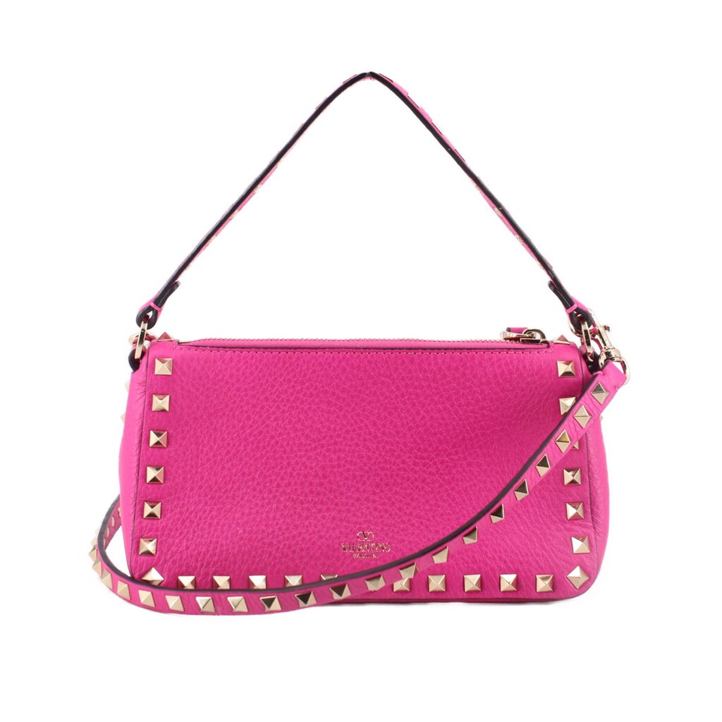 Pink studded crossbody bag with gold-tone hardware and top handle strap