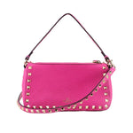 Pink studded crossbody bag with gold-tone hardware and top handle strap